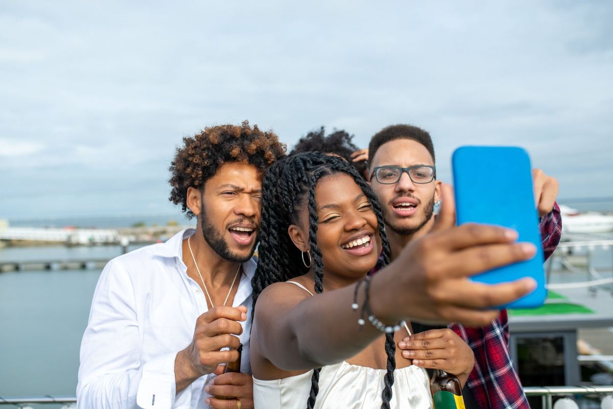 Friends posing for a photo on a harbour deck